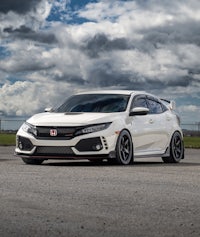 a white honda civic type r parked on a road